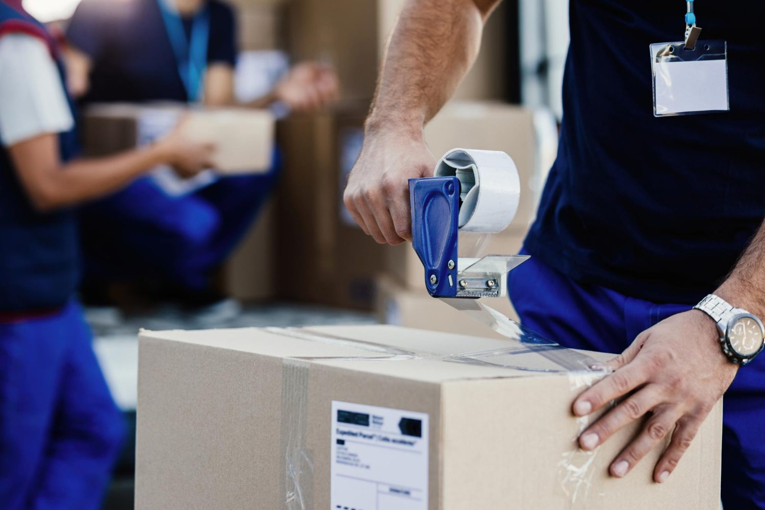 closeup-delivery-man-closing-carboard-box-with-tape-while-preparing-packages-shipment Packaging
