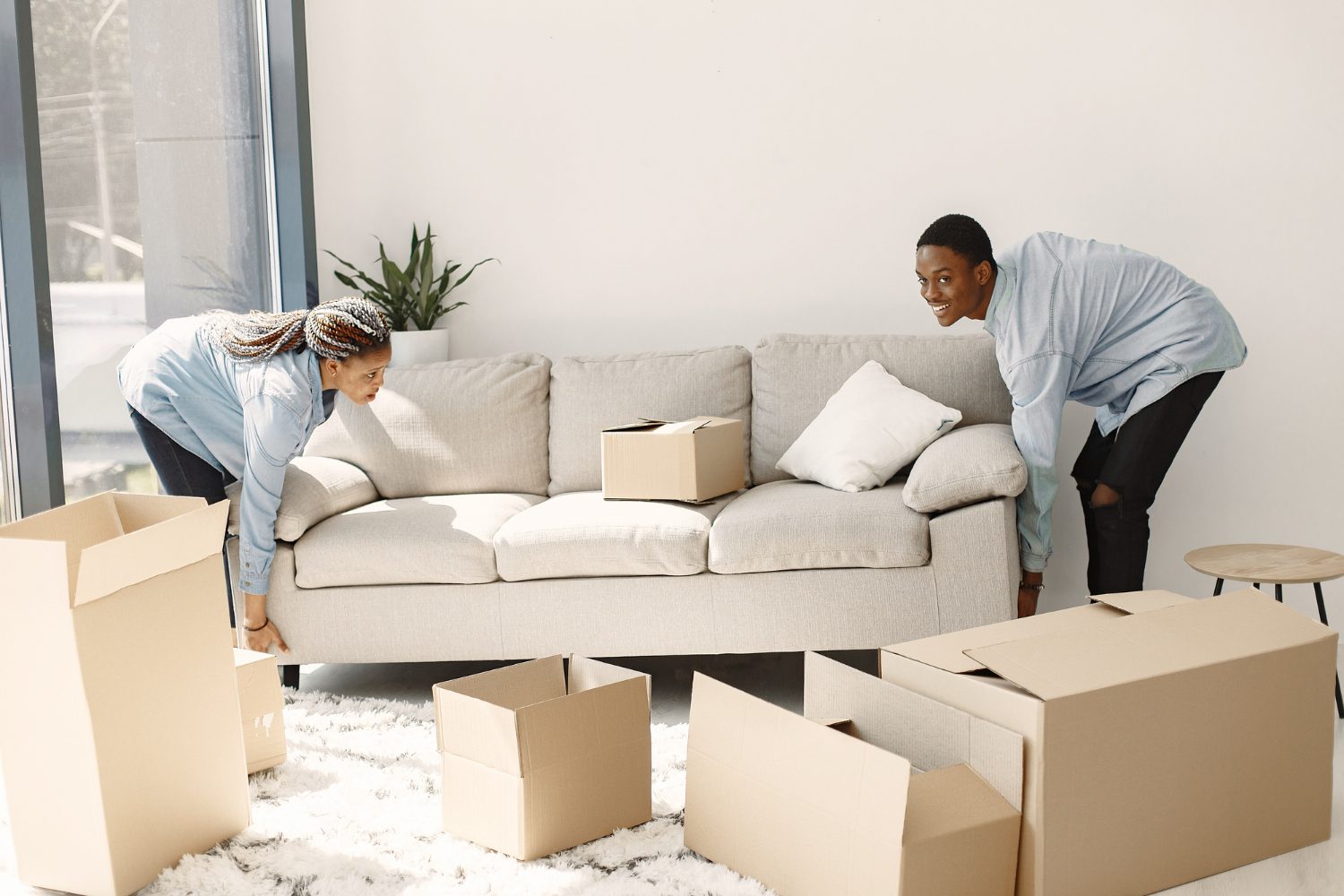 young-couple-moving-new-home-together-african-american-couple-with-cardboard-boxes Moving Sofa